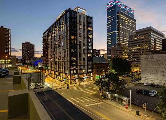 A night view of a city with Artistry on 10th at the center