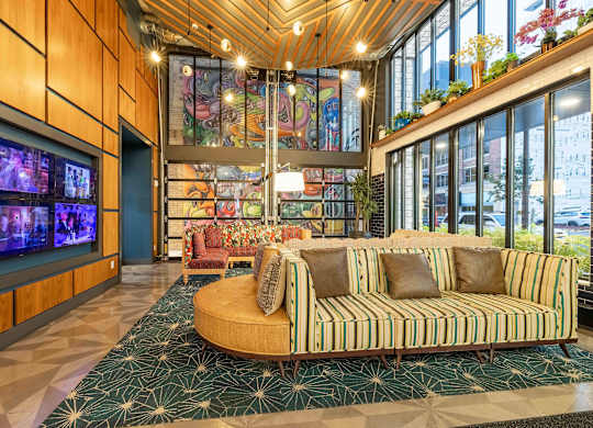 a lobby with two chairs and a wall of windows