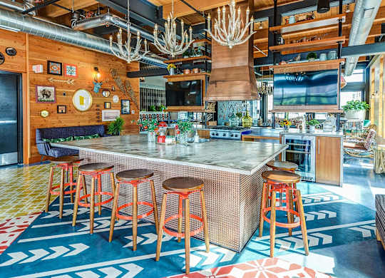 a bar with stools and a large counter in a restaurant