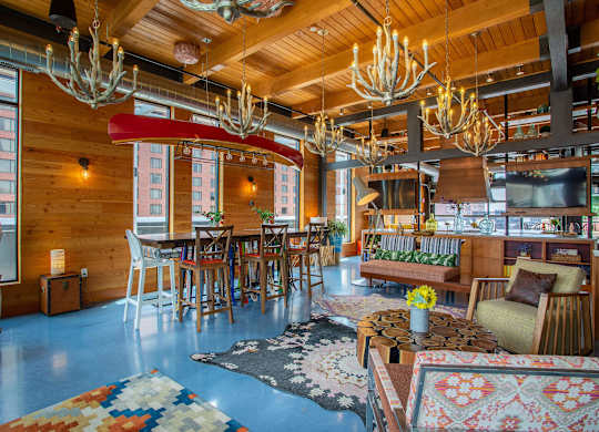 a living room and dining room with wooden ceilings and chandeliers