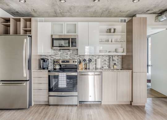 a kitchen with stainless steel appliances and white cabinets