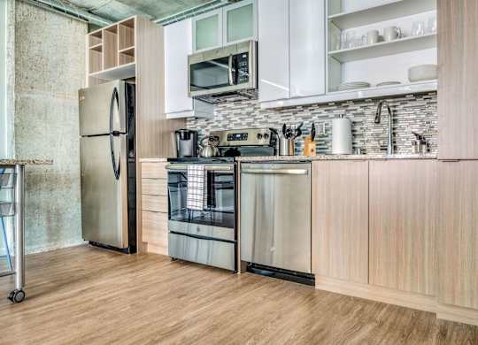 a kitchen with stainless steel appliances and wooden cabinets