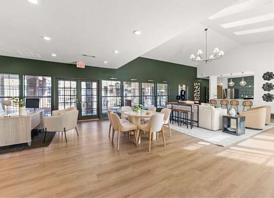 A spacious room with wooden floors and furniture.
