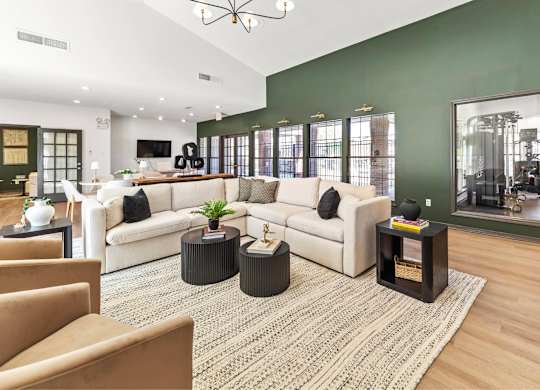 A living room with a white couch, a coffee table, and a rug.