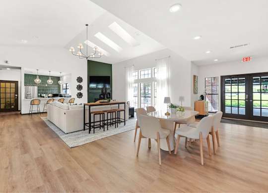 A modern kitchen with a dining table and chairs.