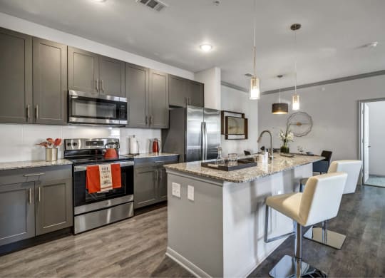 a kitchen with stainless steel appliances and a counter top