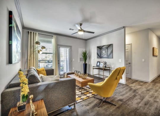 a living room with a yellow chair and a table