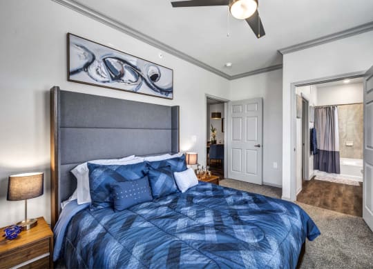 a bedroom with a bed and a ceiling fan