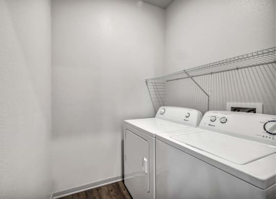 a washer and dryer in a laundry room with white walls