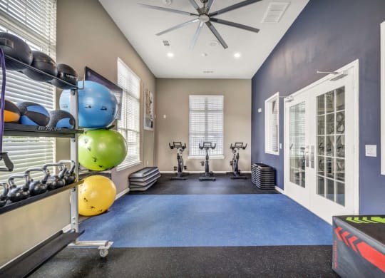 the gym with weights and cardio equipment at the flats at west end apartments