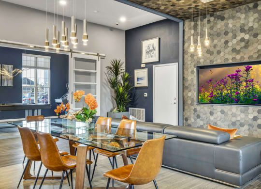 a dining room with a glass table and a couch
