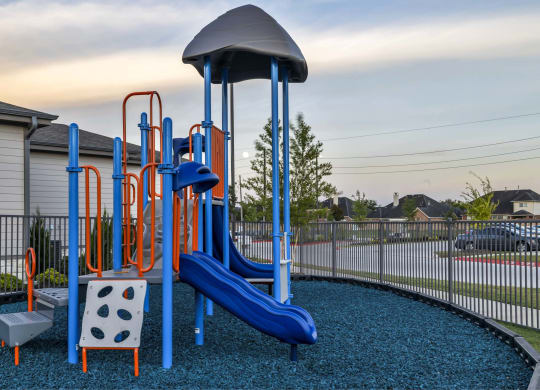 a playground with a swing set and slides