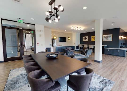 A conference room with a long table surrounded by chairs