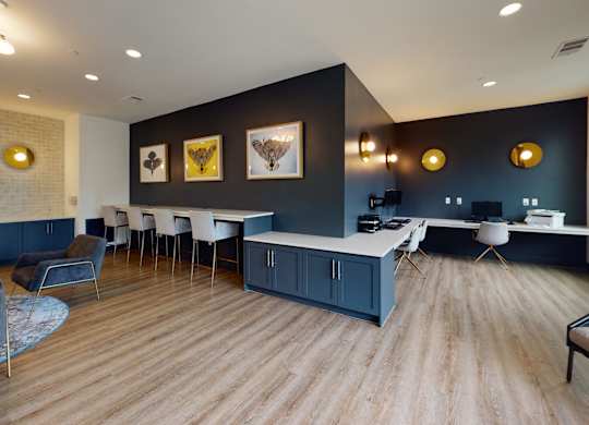 A modern living room with a grey couch and a wooden floor.