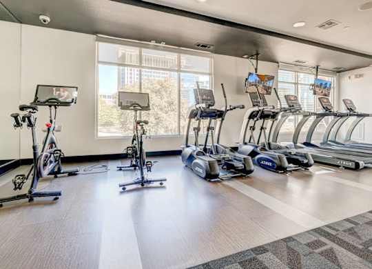 A gym with treadmills, exercise bikes, and elliptical machines.