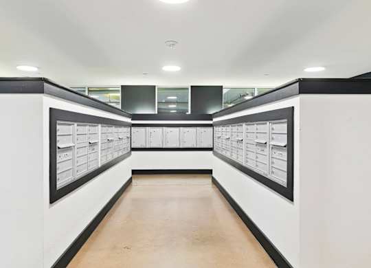 A long hallway with white walls and black trim.