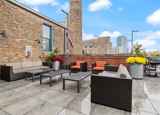 A patio with a table and chairs is set up on a rooftop.