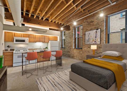 A bedroom with a bed, chairs, and a kitchen area.