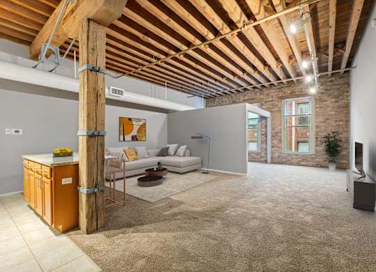 A living room with a wooden beam ceiling and a couch.