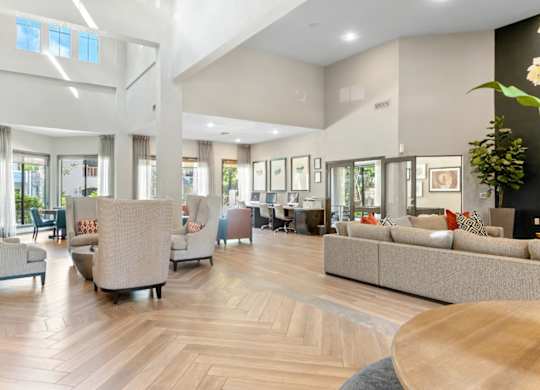 A spacious living room with a wooden floor and furniture.