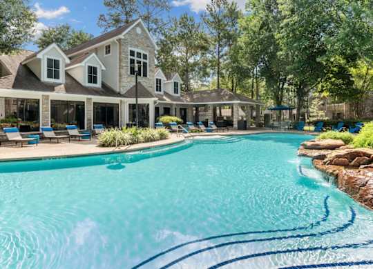 A large house with a pool in front.