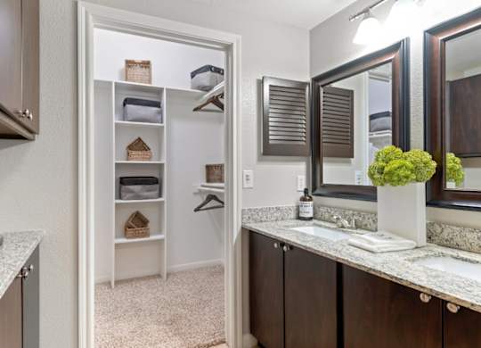 A kitchen with a white refrigerator and wooden cabinets.