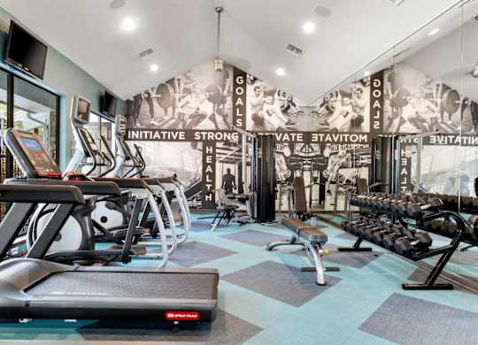 A gym with treadmills, exercise bikes, and weight machines.
