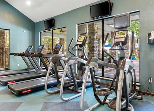 A gym with treadmills and exercise bikes.