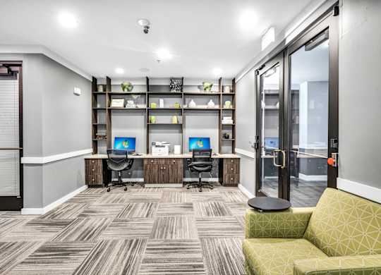 A work space with a green sofa and desk space at Markethaus 3700 in Plano Texas