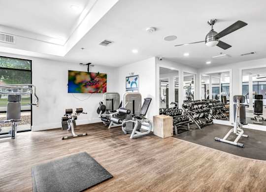 A spacious gym with a mirrored wall at Markethaus 3700 in Plano Texas