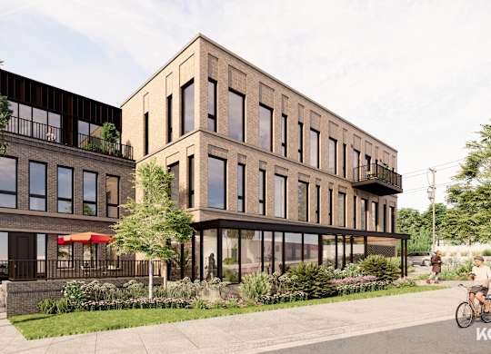 A modern building with a balcony and a bicycle parked in front.