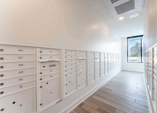 A hallway with a series of mailboxes numbered from 100 to 111.