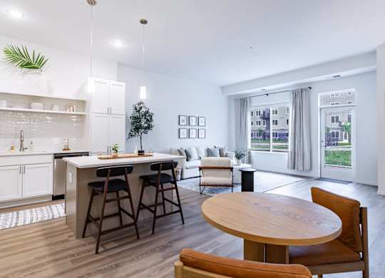 A modern kitchen with a dining table and chairs.