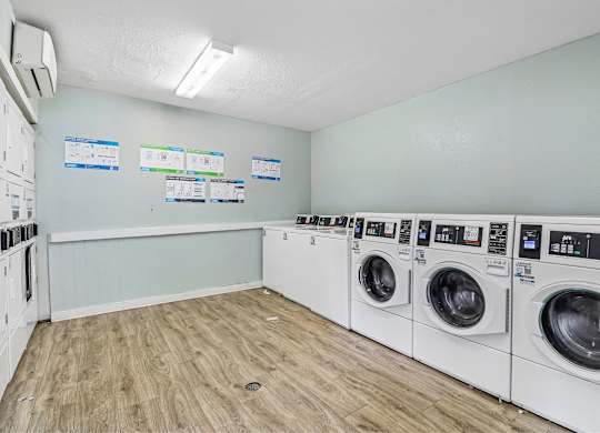 A row of washing machines in a laundromat.