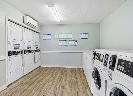 A laundry room with washers and dryers.