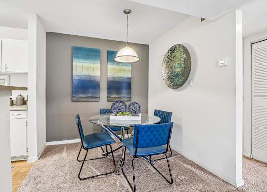 A dining room with a table set for two.