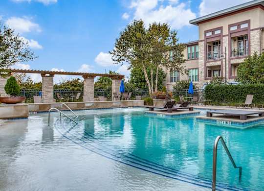 Outdoor pool and lounge area at Twin Creeks Crossing, Allen apartments