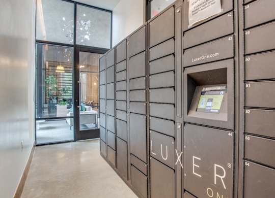 A row of Luxeer One mailboxes are lined up on a wall at Twin Creeks Crossing