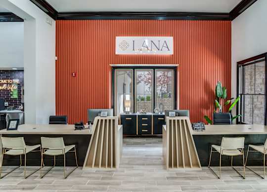 Reception area with a red wall at The Lana Apartments