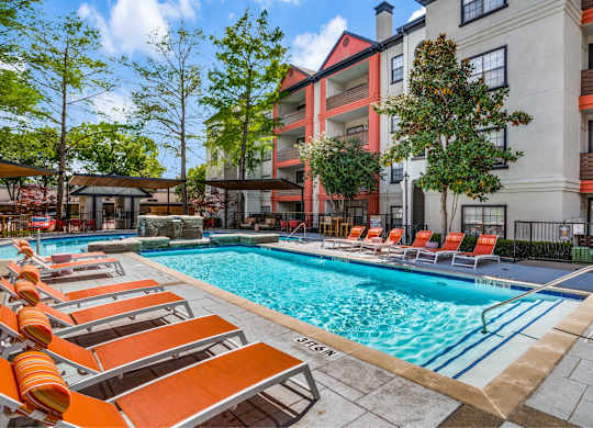 Outdoor pool and lounge chairs at The Lana, Dallas apartments