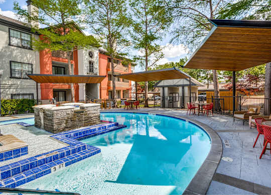 Swimming pool with poolside seating at The Lana, apartments in Dallas
