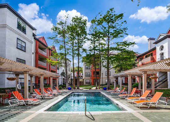 Swimming pool with poolside seating at The Lana, Dallas apartments