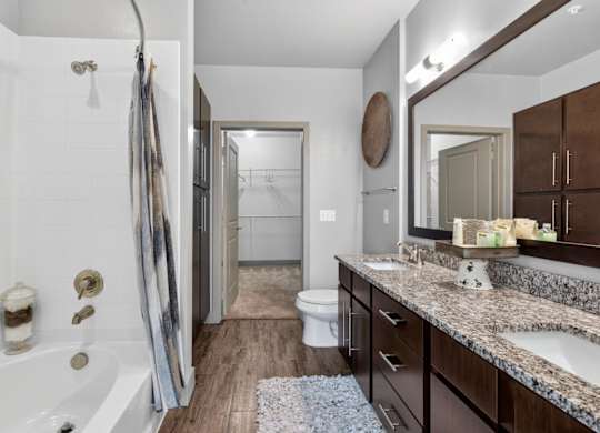 Bathroom with dual vanity at The Carson at Twin Creeks, apartments in Allen