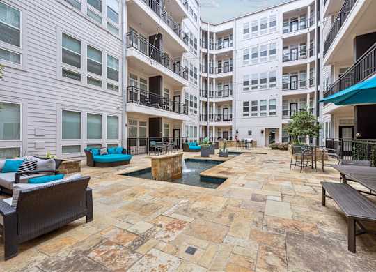 A courtyard with a pool and seating area.
