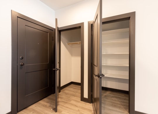 a bedroom with a medium sized wardrobe and a large mirror