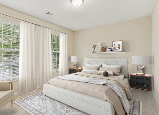 A bedroom with a large bed and a chair.