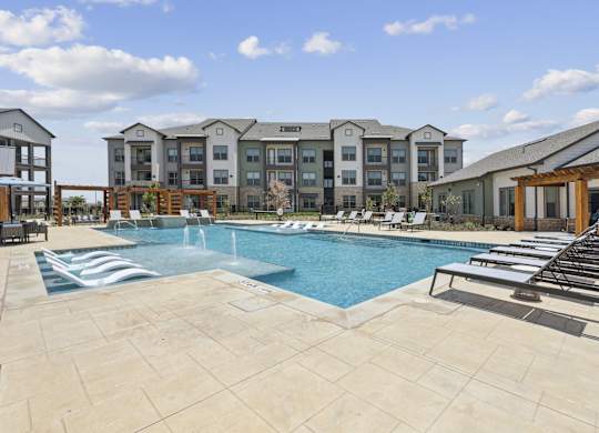 a swimming pool with lounge chairs and cabanas