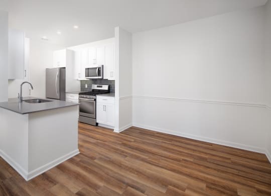 Vacant dining room with kitchen adjacent