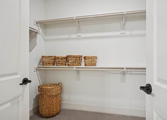 A white hallway with a basket on the floor.