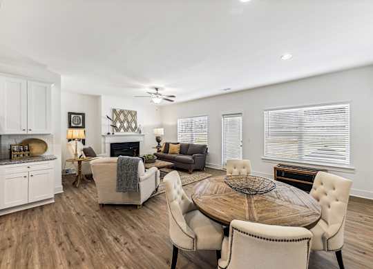 a living room with a table and chairs and a fireplace